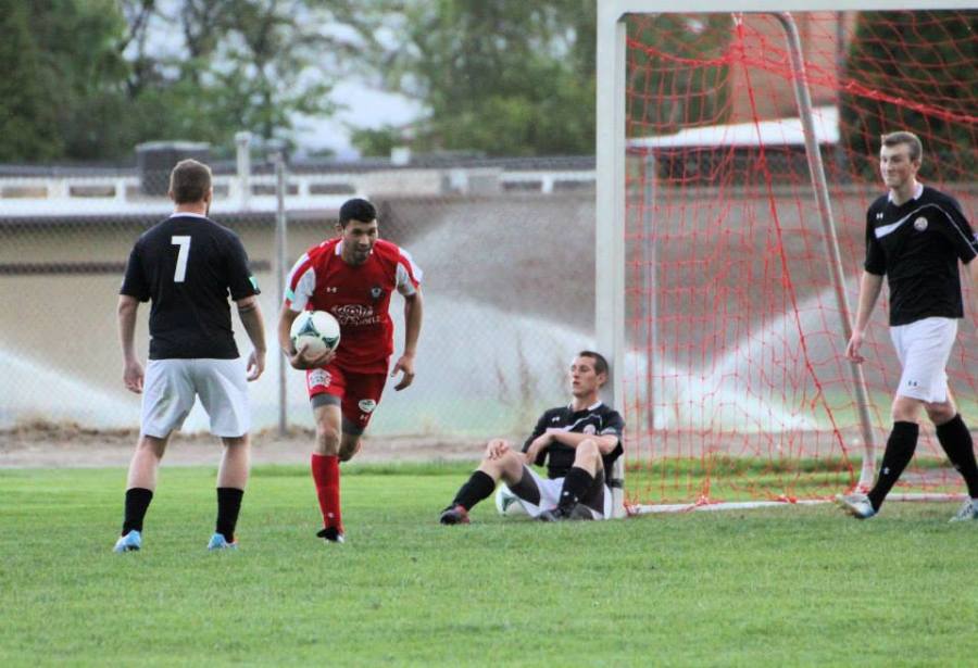 Hector Valdovinos gets the ball back after scoring against WestSound FC. (Tracie Fowler.)