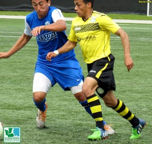 Izzy Deluna (left, Olympic Force) tries to keep up with Eleazar Galvan (right, Wenatchee FC.) (David Falk)